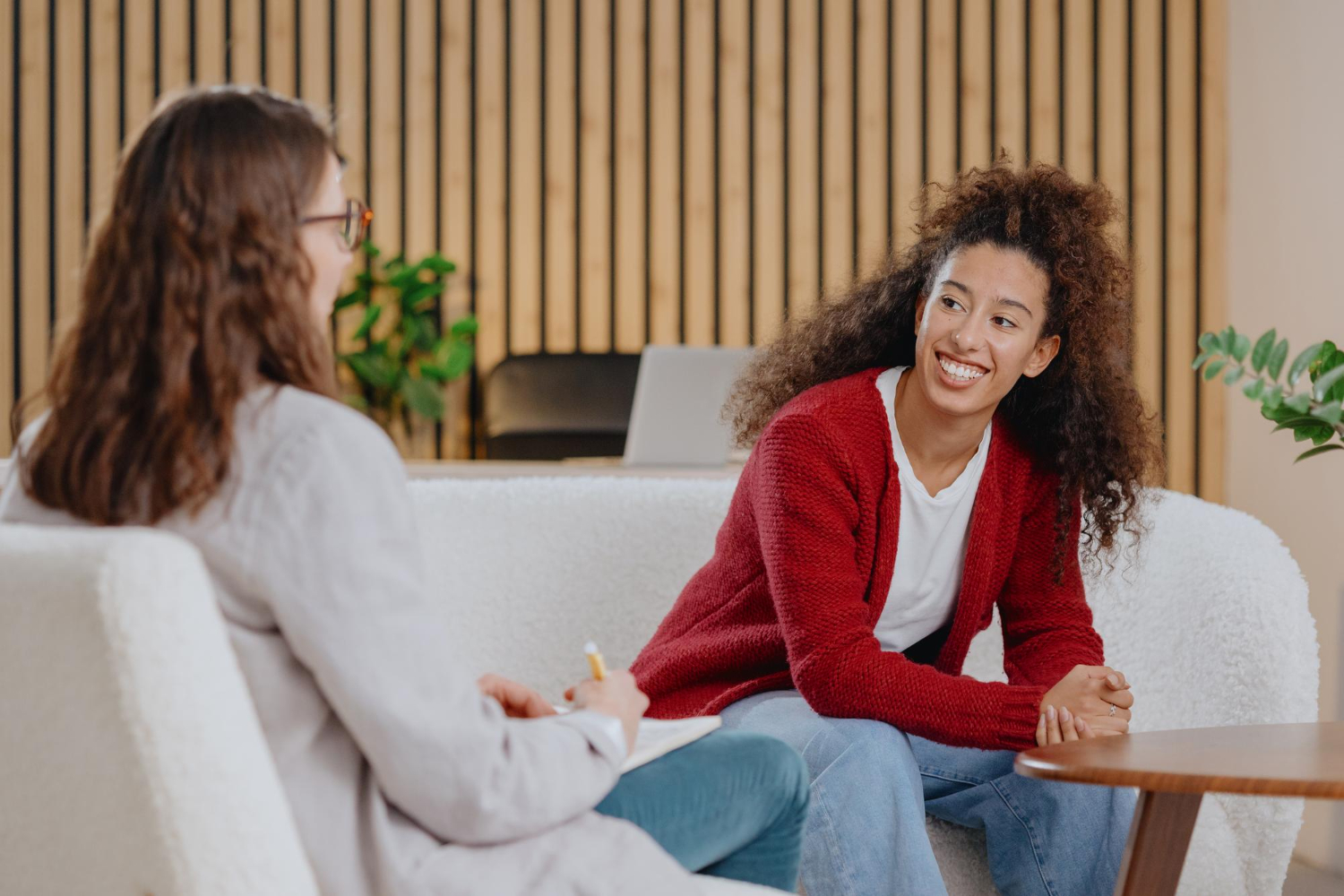 A clinician and patient in a warm, supportive therapy session